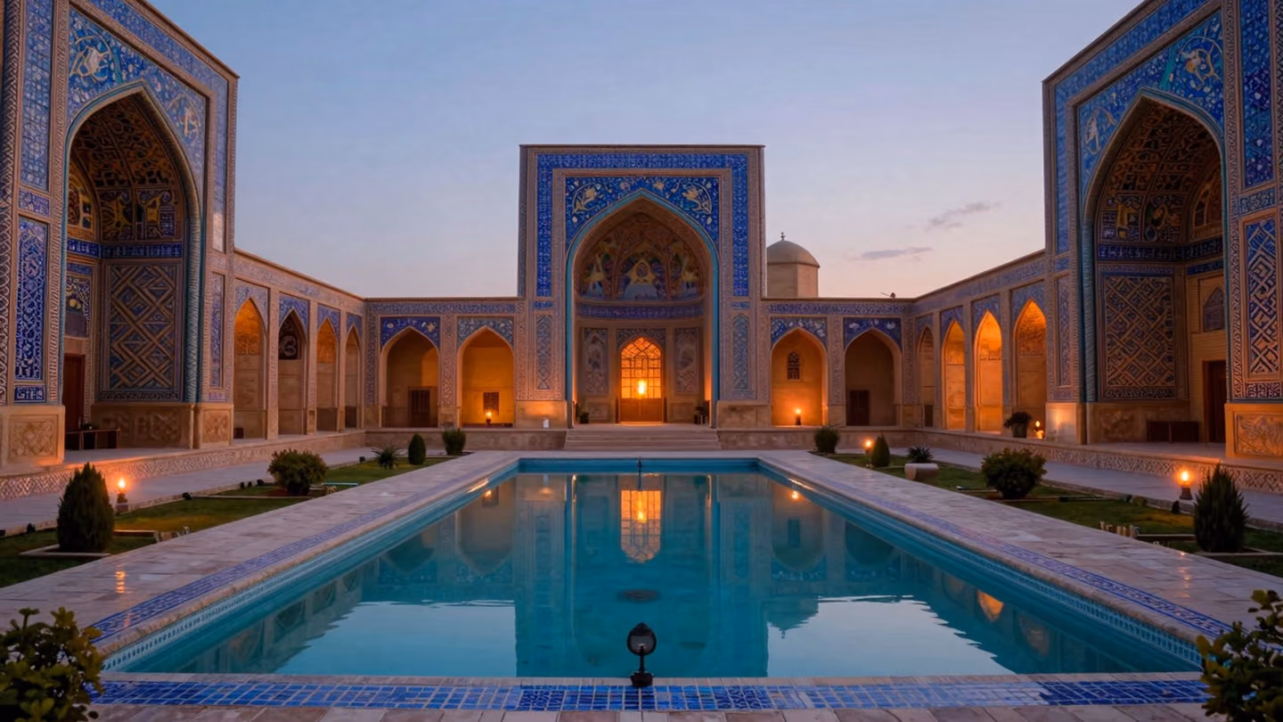 Vast wide shot of a symmetrical Persian courtyard garden at dusk, featuring a still turquoise reflecting pool mirroring the twilight sky, framed by intricate geometric tile patterns.