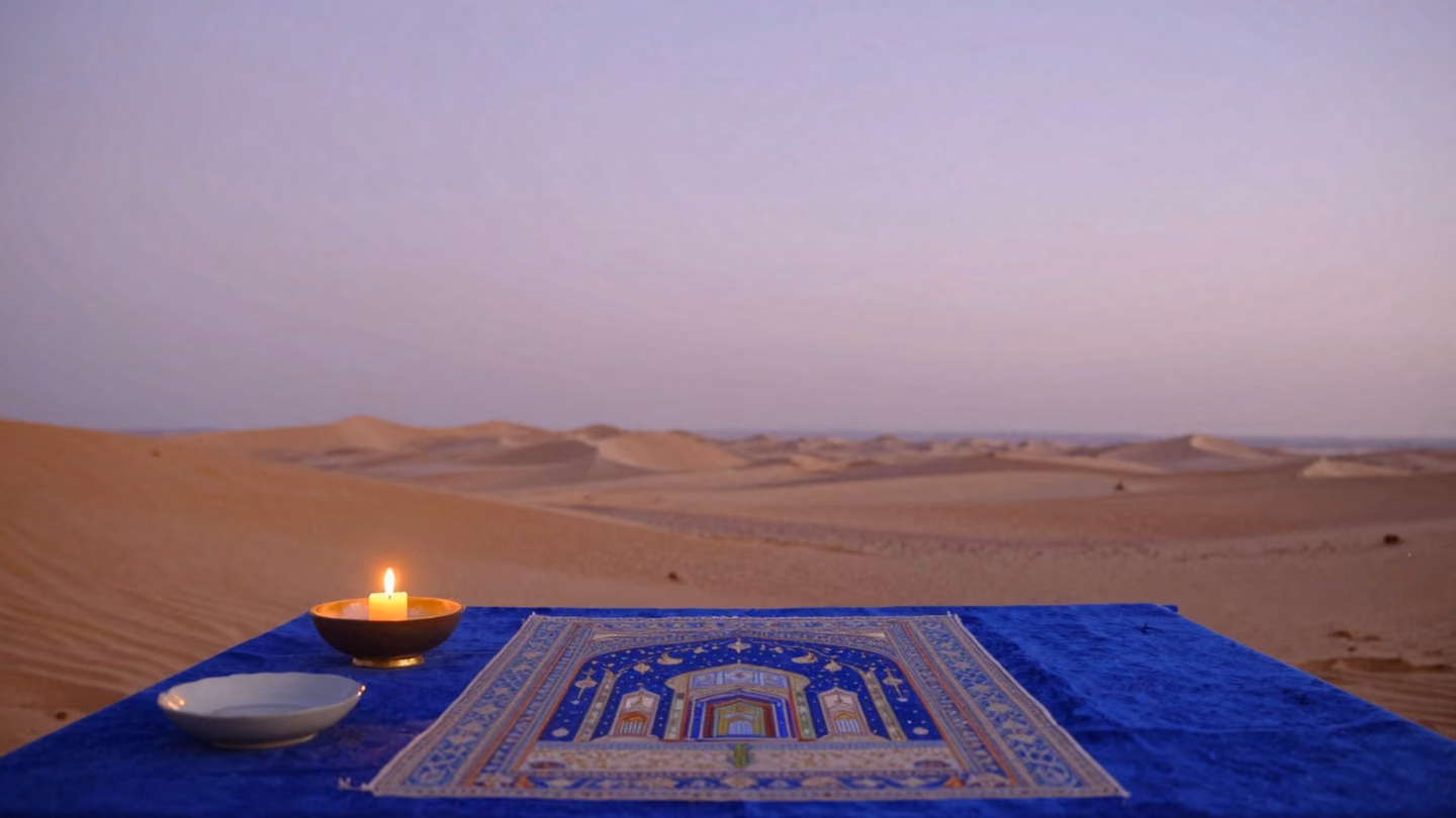Wide shot of an endless, empty desert horizon transitioning into the soft, pale lavender light of pre-dawn, conveying a sense of quiet closure and infinite space.