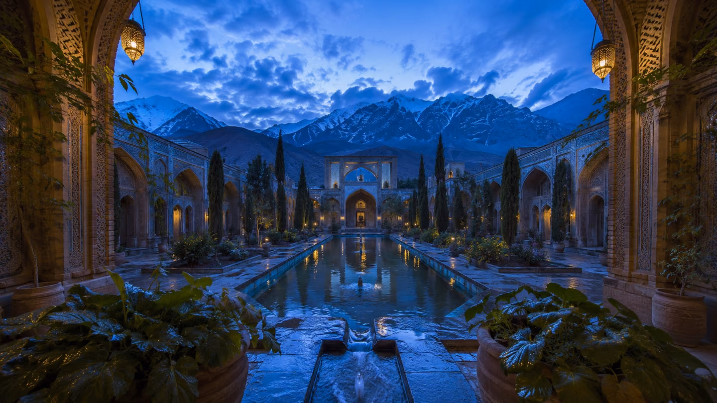 Medium wide shot of a tranquil Persian garden courtyard at dusk — cold blue shadow has settled over a central reflecting pool that mirrors the cooling sky, while moisture beads on stone channels and broad-leafed plant…