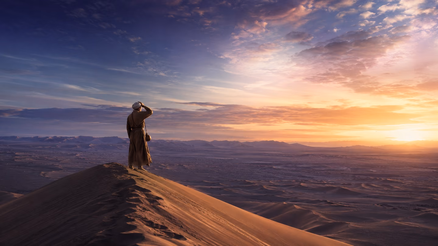 Medium shot — the lone dervish seeker (first motif appearance): a distant solitary figure in a worn wool khirqa and simple turban stands on the crest of a sweeping desert dune, shielding his eyes with one hand and gaz…