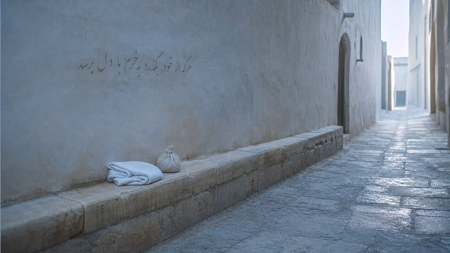 The lane entirely empty now — looking down from above at the stone ledge running along one wall: a folded cotton headcloth and a small knotted bundle rest on the ledge, unclaimed, their owner having passed beyond name…